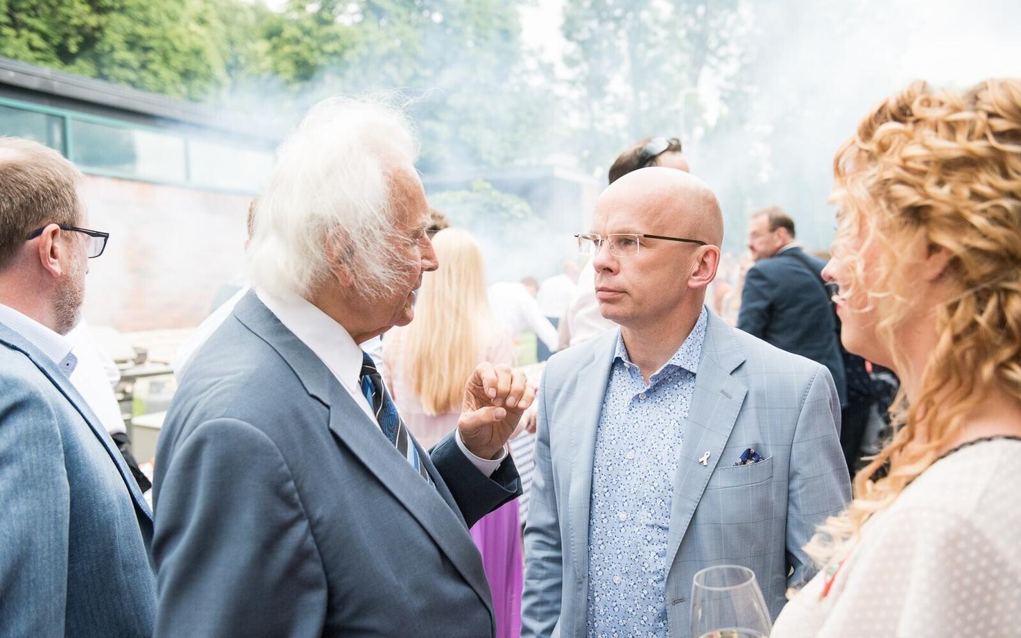 Presidential candidate Allar Jõks (right) speaking with former President of Estonia Arnold Rüütel (left) at a US Embassy reception. July 2016.