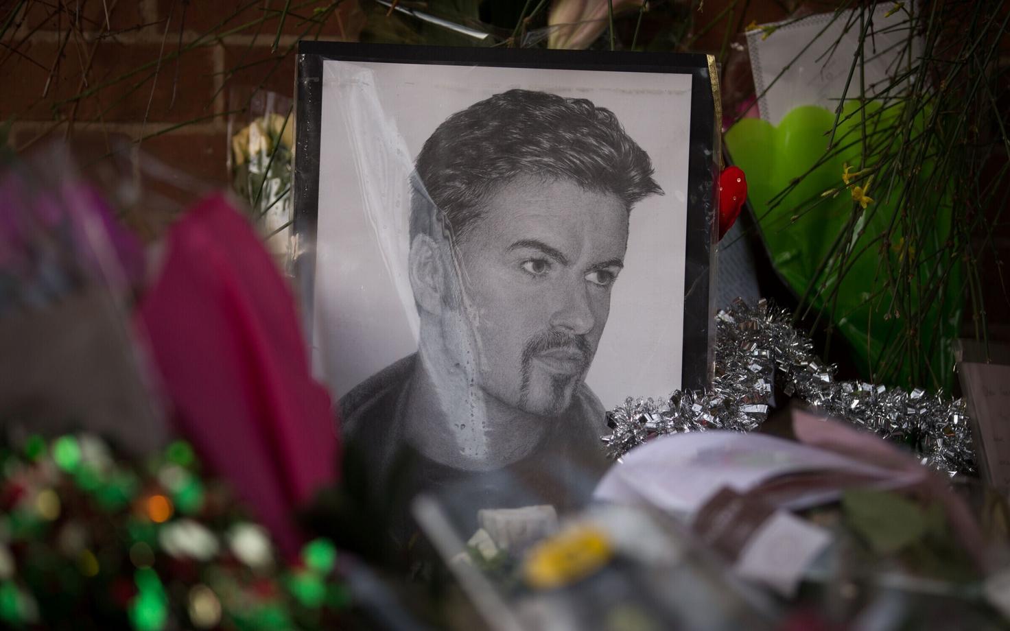 George Michaeli pilt ja leinajate poolt toodud lilled laulja kodu ees.