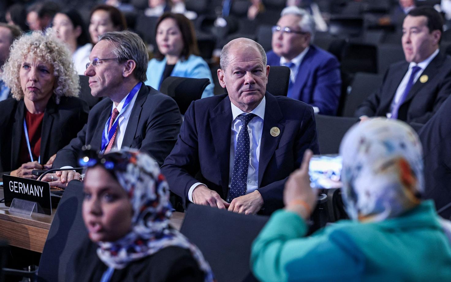 Üks COP27 kliimakonverentsil osaleja teeb Saksa kantsler Olaf Scholzist oma nutitelefoniga pilti