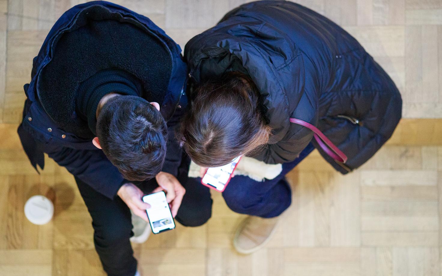 Teens looking at smartphones. Photo is illustrative,